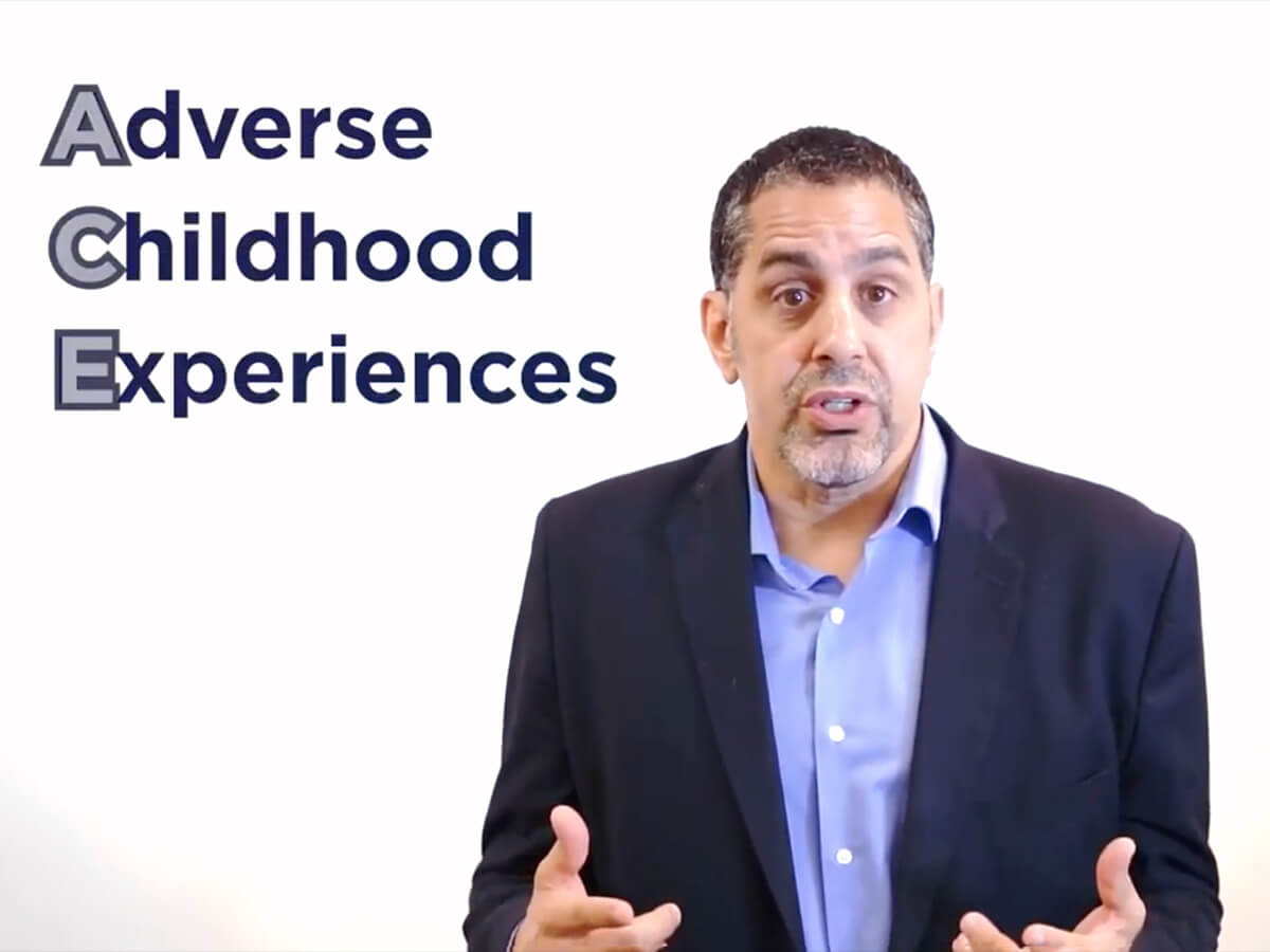A still image of Dr. Jim rodriguez explaining the concept of Adverse Childhood Experience in the video