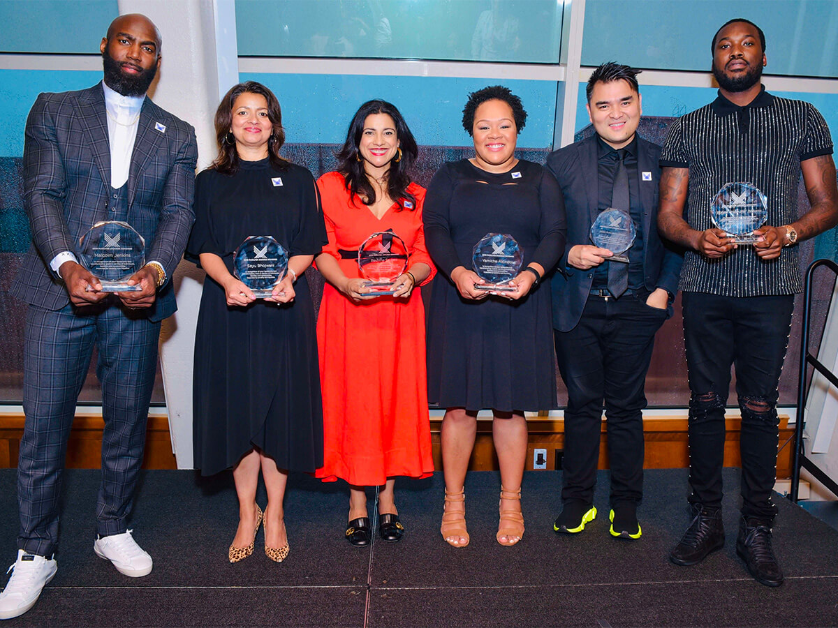 The 2019 McSilver Awards honorees, standing in a line and holding their awards