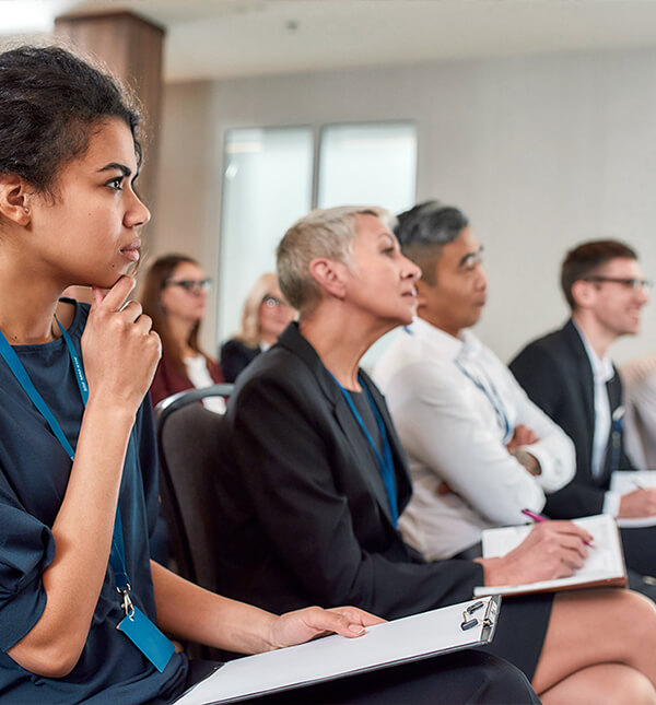 Photo of diverse professionals listening attentively to a presentation