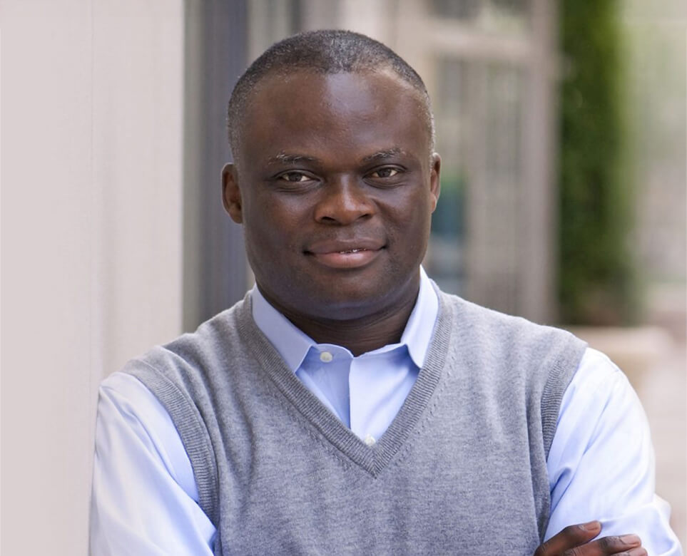 Portraid of Dr. Fred wearing a smart vest and leaning on an outdoor campus wall